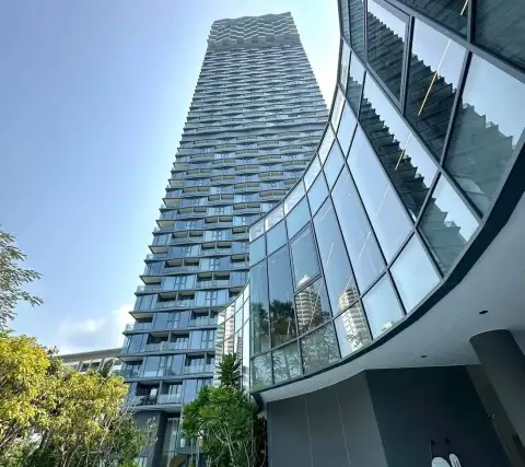 1 Bedroom Condo for Rent at Arom Wongamat high-rise tower exterior with curved glass lobby facade