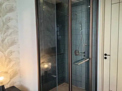 1 Bedroom Condo for Sale at Arom Wongamat glass-enclosed shower with tiled walls in bathroom