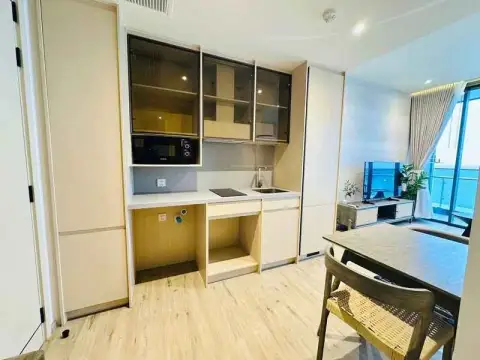 1 Bedroom Condo for Rent at Arom Wongamat compact kitchenette with sink, stove and cabinets