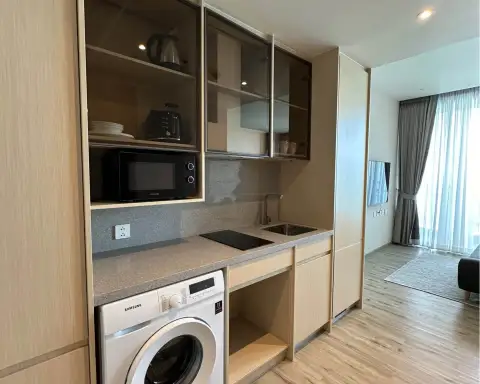 1 Bedroom Condo for Rent at Arom Wongamat kitchenette with microwave, washer and built-in cabinets