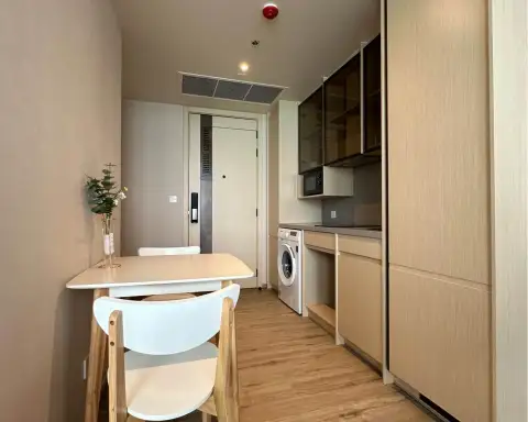 1 Bedroom Condo for Rent at Arom Wongamat entryway with dining table, kitchenette and front door