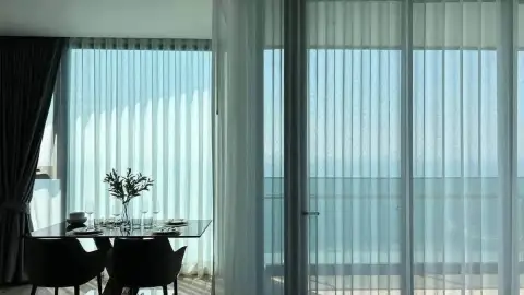 2 Bedroom Condo for Rent at Arom Wongamat dining table by sheer curtains with sea view