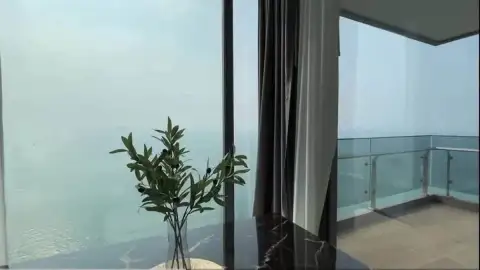 2 Bedroom Condo for Rent at Arom Wongamat balcony view of the ocean with marble table and plant