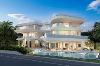ASONGKHAI Front view of a contemporary house with large windows, curved architecture, and a ground-level swimming pool.