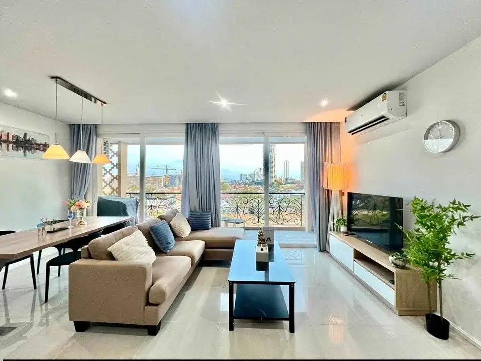 2 Bedroom Condo for Sale at Atlantis Condo Resort living room with sectional sofa and balcony city view