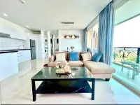 2 Bedroom Condo for Sale at Atlantis Condo Resort lounge area with glass coffee table and floor-to-ceiling windows