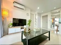 2 Bedroom Condo for Sale at Atlantis Condo Resort TV entertainment unit with decorative shelving and wall clock