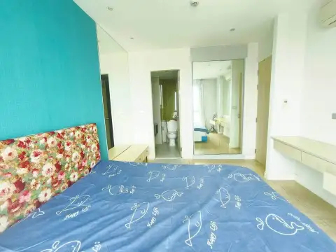 1 Bedroom Condo for Sale at Atlantis Condo Resort bedroom with teal accent wall and en-suite bathroom view