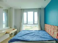 1 Bedroom Condo for Sale at Atlantis Condo Resort bedroom with city view window and floral headboard