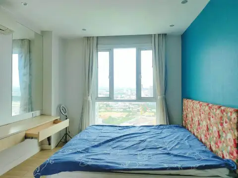 1 Bedroom Condo for Sale at Atlantis Condo Resort bedroom with city view window and floral headboard