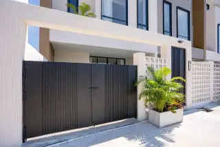 Aura Villa Reserve rooftop terrace with a large umbrella, outdoor seating, and a daybed canopy.