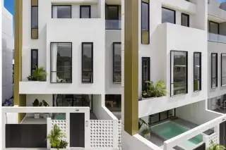 Aura Villa Reserve modern exterior with multiple levels, black-framed windows, and small plunge pool.