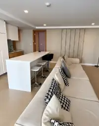 2 Bedroom Condo for Sale at Aurora Pratumnak open-plan living area with sectional sofa and white kitchen island