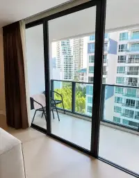 2 Bedroom Condo for Sale at Aurora Pratumnak private balcony with chairs overlooking city skyline and greenery
