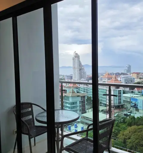 1 Bedroom Condo for Rent at Axis Pattaya Condo balcony with seating area overlooking city and sea view