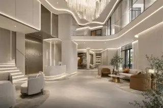Spectra Residence grand luxury lobby with double-height ceiling, crystal chandelier, reception desk and elegant lounge seating
