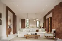 3 Bedroom House for Sale at Solava Pattaya spacious living room with white sofa, walnut wood panels, and brass pendant lights