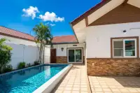 2 Bedroom House for Rent long narrow swimming pool next to the house exterior and a tiled patio area.