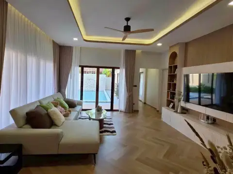 4 Bedroom House for Rent at Baan Balina 3 living room with wood floors, ceiling fan, and pool view