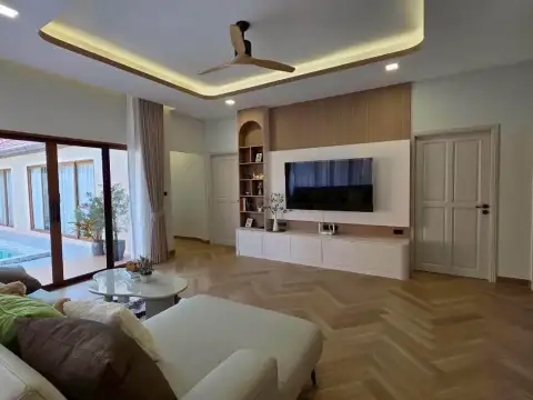 4 Bedroom House for Rent at Baan Balina 3 living room with TV wall unit and herringbone wood flooring