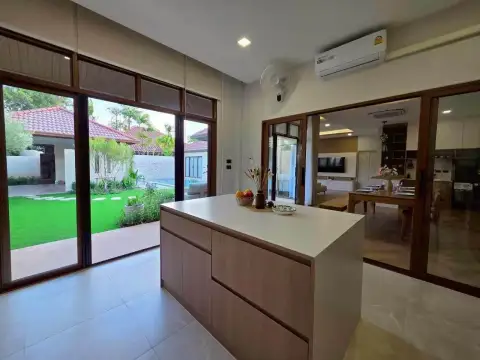 4 Bedroom House for Rent at Baan Balina 3 modern kitchen island with garden and pool view