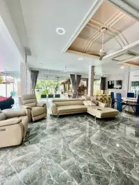 4 Bedroom House for Rent at Baan Balina 3 open-plan living room with marble floors and leather sofas