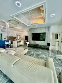 4 Bedroom House for Rent at Baan Balina 3 living room with large wall-mounted TV and marble flooring