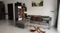 3 Bedroom House for Rent at Baan Dusit Garden 6 living room with gray sectional sofa and wall art