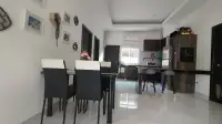 3 Bedroom House for Rent at Baan Dusit Garden 6 dining area with black leather chairs and kitchen view