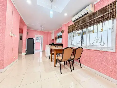 4 Bedroom House for Rent at Baan Fah Rim Haad open dining space with wooden chairs near kitchen and windows