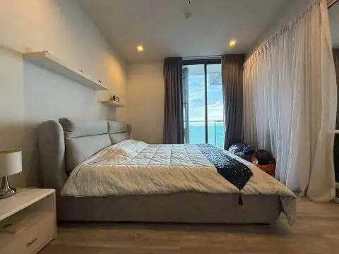 1 Bedroom Condo for Sale at Baan Plai Haad bedroom with ocean view through sliding glass doors