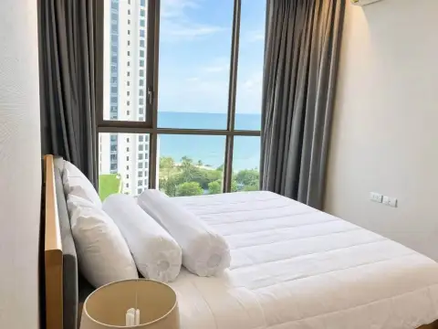 2 Bedroom Condo for Rent at Baan Plai Haad bedroom with bed and floor-to-ceiling windows showing ocean view