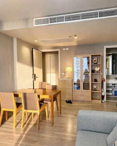 2 Bedroom Condo for Rent at Baan Plai Haad dining area with wooden table, chairs, and glass display cabinet