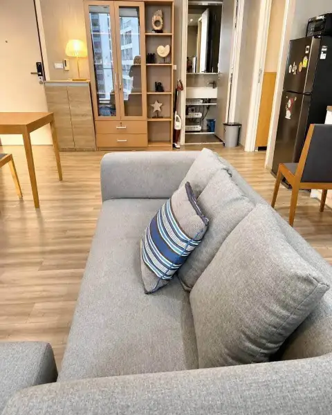 2 Bedroom Condo for Rent at Baan Plai Haad gray sofa with striped cushion near kitchen and refrigerator
