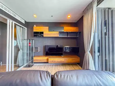 2 Bedroom Condo for Rent at Baan Plai Haad living area with wall-mounted TV and wood cabinetry