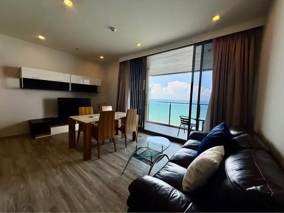 2 Bedroom Condo for Rent at Baan Plai Haad living room with leather sofa, dining table and ocean-view balcony