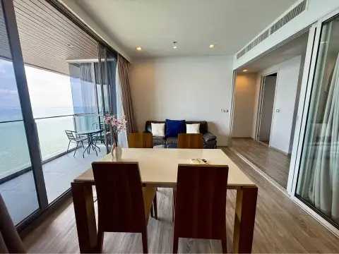 2 Bedroom Condo for Rent at Baan Plai Haad dining area with sea view balcony and sliding glass doors