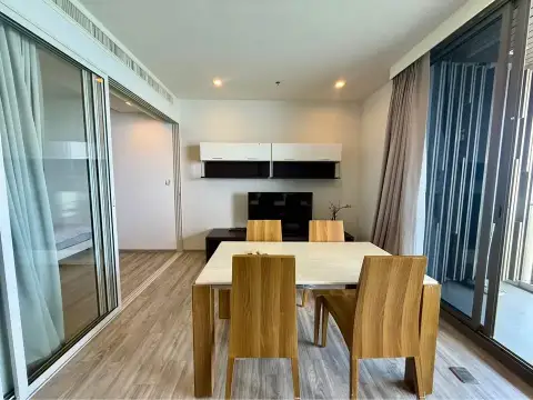 2 Bedroom Condo for Rent at Baan Plai Haad wooden dining table with TV unit and hallway to bedrooms