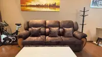 1 Bedroom Condo for Sale at Baan Suan Lalana brown suede sofa with city skyline art and exercise bike