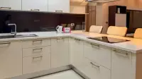 1 Bedroom Condo for Sale at Baan Suan Lalana kitchen counter with sink, stove, and bar seating