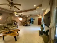 4 Bedroom House for Sale in Bang Lamung spacious living area with tray ceiling, ceiling fans, and wall-mounted TV