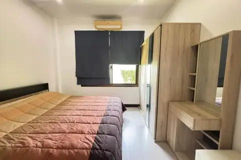 3 Bedroom House for Rent in Bang Sare bedroom with queen bed, wood wardrobe, and vanity desk