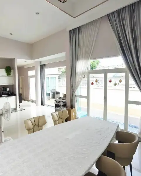 3 Bedroom House for Rent in Bang Sare dining area with draped curtains and view of outdoor terrace