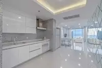 3 Bedroom Condo for Sale at Bay View Resort modern white kitchen with mosaic tile backsplash and ocean view
