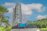 3 Bedroom Condo for Sale at Bay View Resort high-rise tower exterior with pool fountain and palm trees