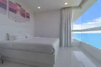 3 Bedroom Condo for Sale at Bay View Resort master bedroom with ocean view and beach-themed wall art