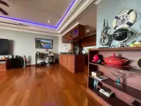 2 Bedroom Condo for Sale at Bay View Resort living area with wooden kitchen cabinets and display shelf