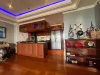 2 Bedroom Condo for Sale at Bay View Resort kitchen with wood cabinetry, fridge, and nautical decor shelf