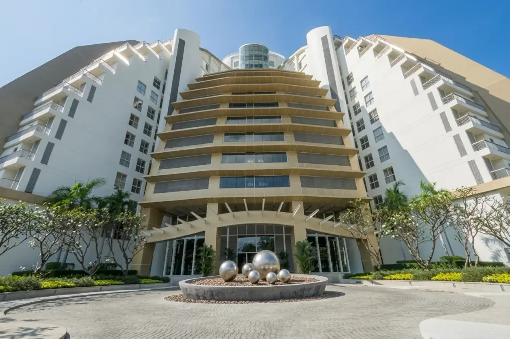 The Cove Pattaya main building exterior with tiered architecture and circular driveway entrance.