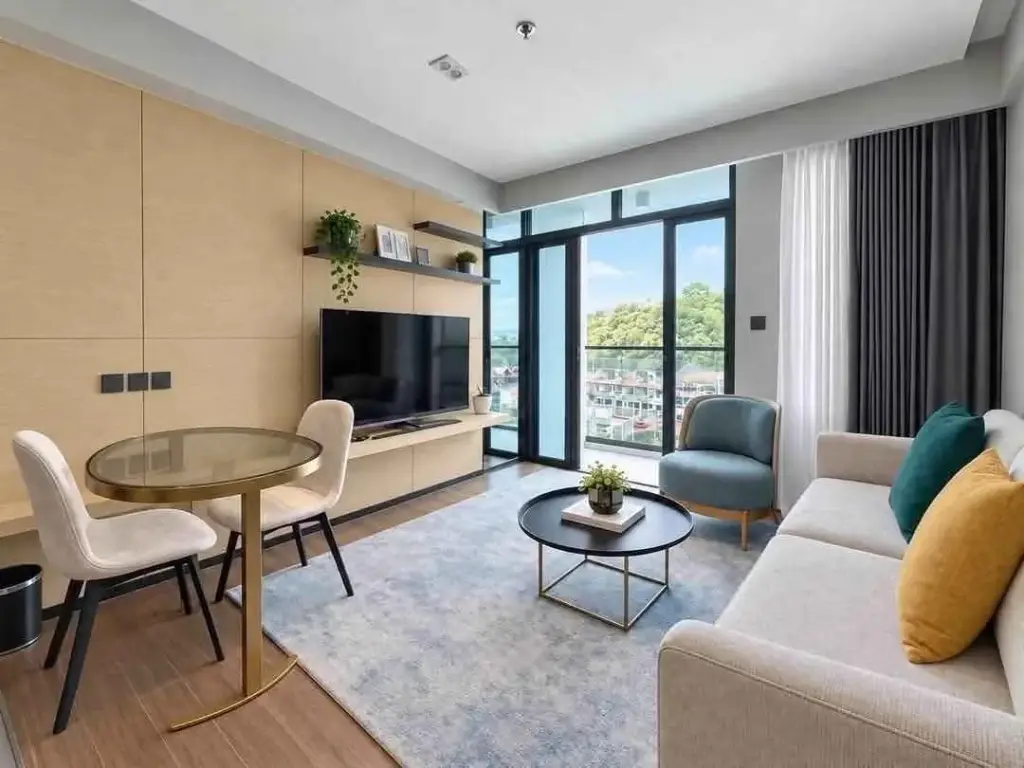2 Bedroom Condo for Rent at Beverly Mountain Bay Pattaya living room with dining table, TV and balcony view